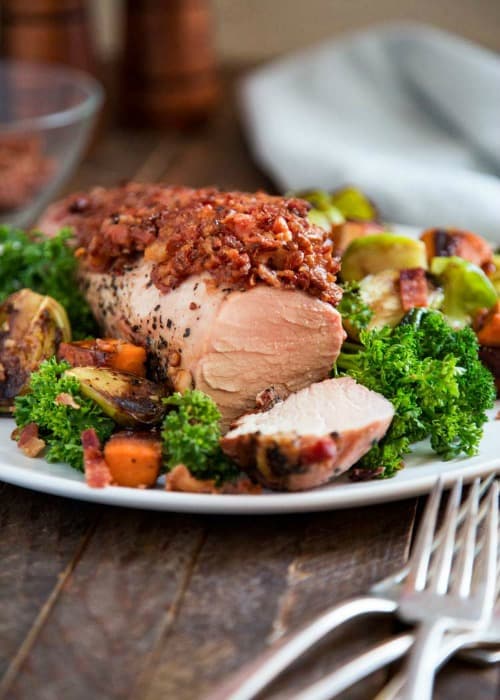 I’ve got loads of new recipes to share with you, especially this Bacon Peppered Pork Tenderloin. Could it get any better? Porkalicious indeed! The pan roasted balsamic glazed sweet potatoes and Brussels sprouts get finished alongside on the grill for a dinner in under 30 minutes.