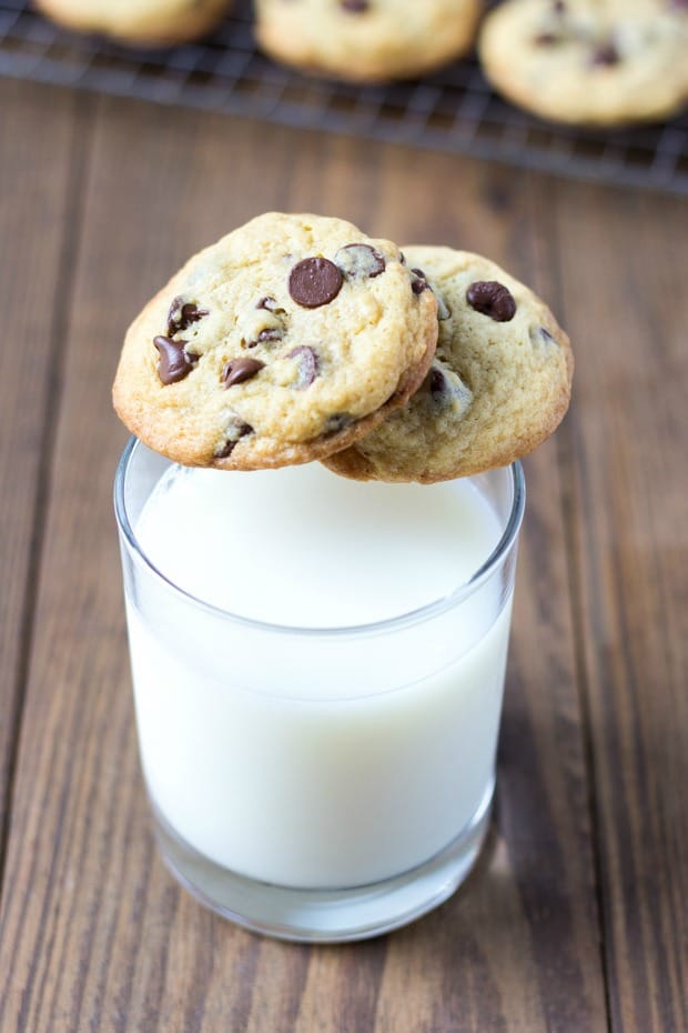 two chocolate chip cookies on glass of milk
