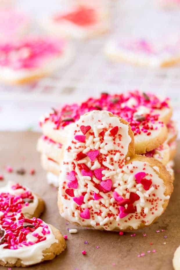 Spread the LOVE this Valentine’s Day with easy frosted Valentine cookies! No matter what your baking skills are, you’ll be able to tackle these simple cookies topped with royal icing and sprinkles.