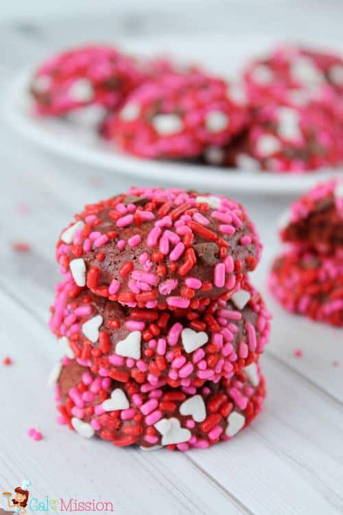 Homemade soft and chewy red velvet cookies. Showered in cute Valentine’s Day festive sprinkles.