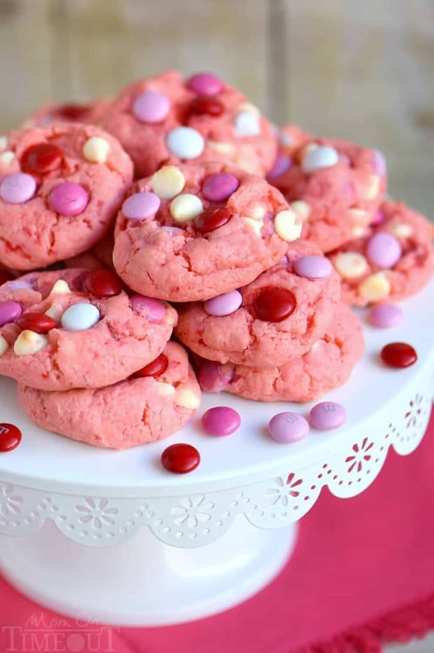Super moist and delicious Strawberry and White Chocolate Cake Mix Cookies! This recipe uses a SECRET INGREDIENT for the moistest cookies EVER! So pretty and pink! Perfect for Valentine’s Day, baby showers and more!