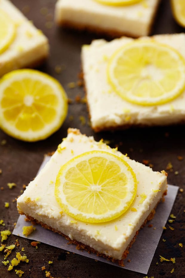 Delicious and creamy lemon cheesecake top a graham cracker crust and chills in the fridge. They are made with lightened up ingredients and make the perfect lemon dessert!