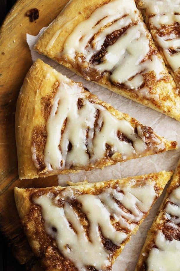 Inspired by Papa Murphy’s Cinnamon Wheel, this dessert pizza has all of the goodness of a cinnamon roll!   A buttery brown sugar cinnamon spread on top of a quick and easy pizza dough, and drizzled with a cream cheese glaze!