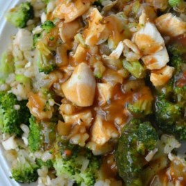 A close up of a plate of food with broccoli, with Chicken and Gravy