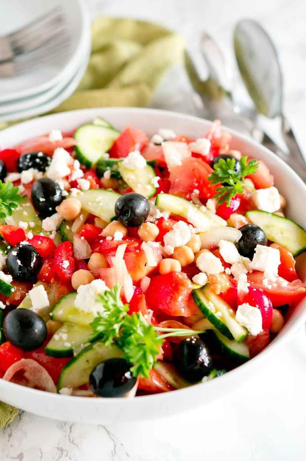 Greek salad is brimming with flavor – loaded with delicious fresh vegetables, olives, chickpeas, and feta cheese tossed in a light and refreshing greek salad dressing.