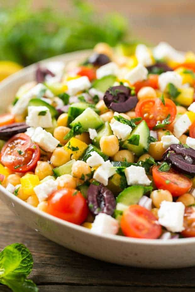 This recipe for Chopped Greek Salad is variety of fresh vegetables with chickpeas, creamy feta cheese and olives, all tossed in a Greek lemon and herb vinaigrette.