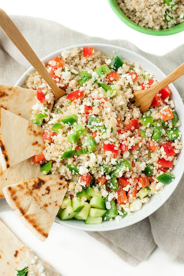 Loaded with fresh veggies and drizzled in a light homemade dressing, these tasty vegetarian Greek Quinoa Bowls make healthy eating a breeze!