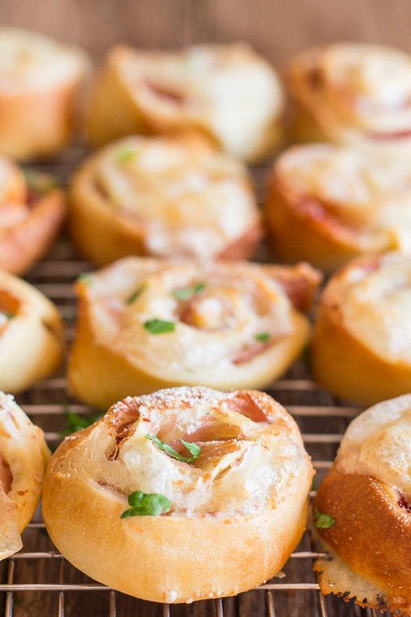 Pizza Roll Ups a fast and easy appetizer. Use a pre made pizza dough and a layer of ham and cheese, roll it up, sprinkle with a little parmesan cheese and bake. So good!