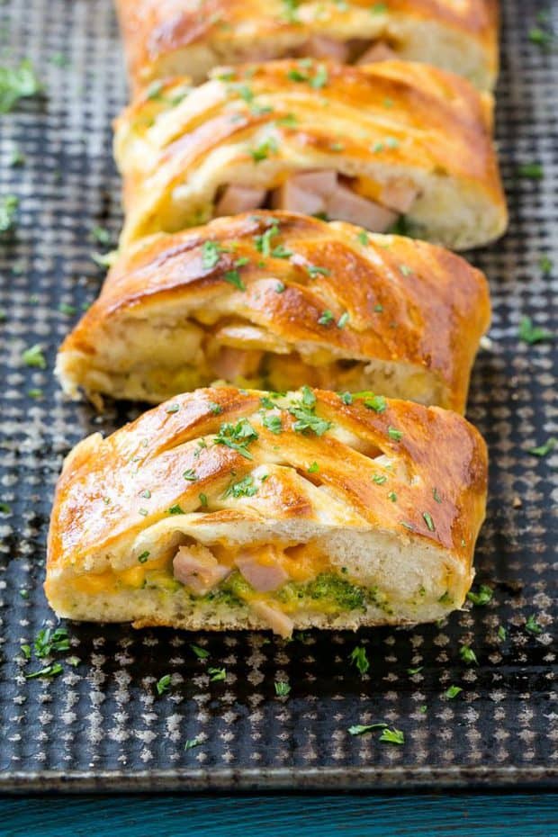This easy Ham and Cheese Stromboli recipe is tender dough stuffed with ham, cheese and brocolli, then baked to a golden brown.  It's a 5 ingredient dinner that's ready in just 30 Minutes!
