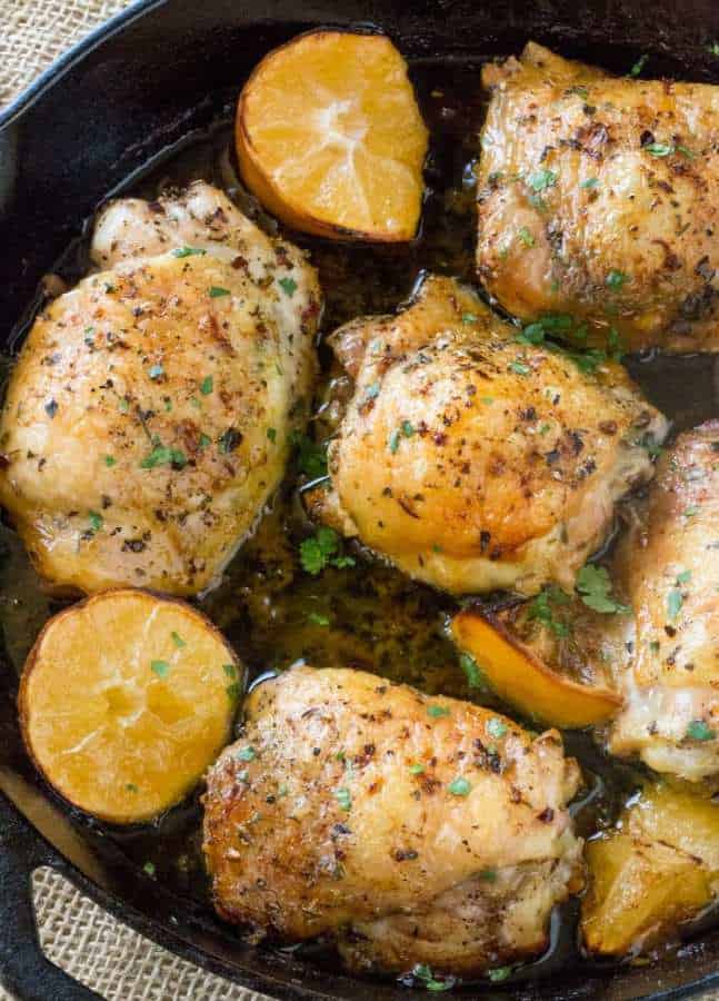 Easy Greek Lemon Chicken is made with just a handful of ingredients in a cast iron skillet along with roasted lemon wedges that we make an easy pan sauce.