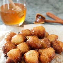 Have you had Loukoumades (Greek Doughnuts) before? I'm drooling just looking at them! They're simple dough balls served warm with cinnamon and honey/syrup. | Featured on The Best Blog Recipes