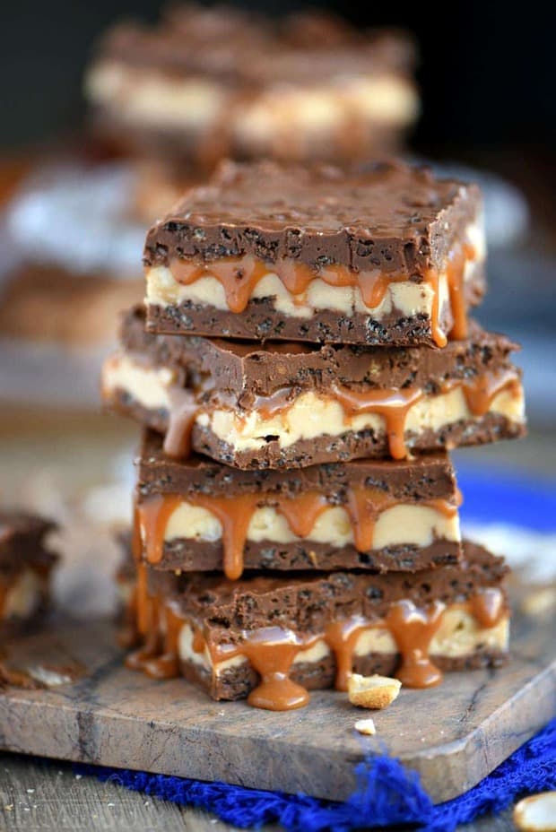 No Bake Snickers Crunch Bars are sure to become a new favorite! Layers of chocolate mixed with crunchy Cocoa Pebbles, irresistible nougat, and gooey caramel are impossible to resist! This recipe makes a lot so be sure to invite friends and family over to enjoy with you! Great for parties!