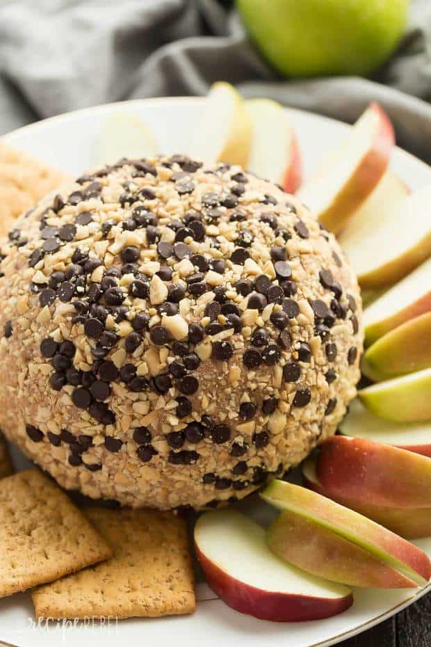 This Snickers Cheese Ball is perfect for holiday potlucks and gatherings! Loaded with caramel, chocolate and peanut butter, it’s perfect served with apple slices, other fruit, and graham crackers.