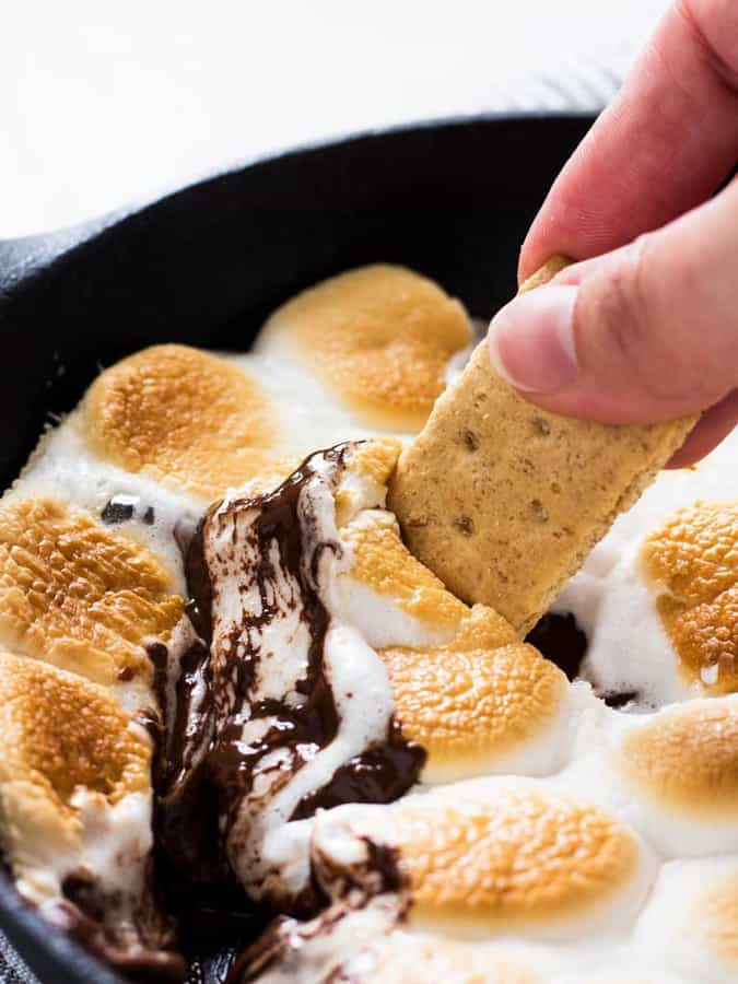 Learn how to make smores dip in a skillet! It is so easy and requires only four ingredients. This summer dessert will be ready in no time!