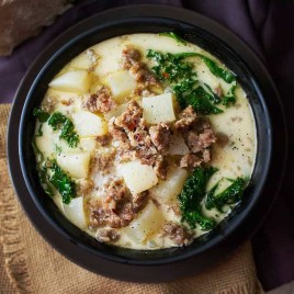 SLOW COOKER ZUPPA TOSCANA SOUP -- a delicious creamy soup with tender potatoes, spicy Italian sausage and healthy kale! | Featured on www.thebestblogrecipes.com