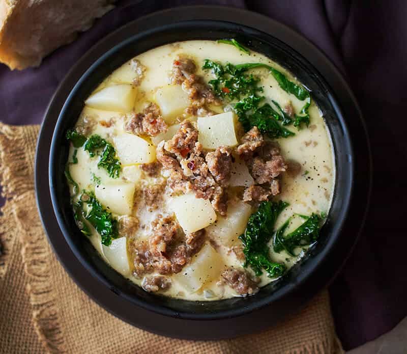 SLOW COOKER ZUPPA TOSCANA SOUP -- a delicious creamy soup with tender potatoes, spicy Italian sausage and healthy kale! | Featured on www.thebestblogrecipes.com