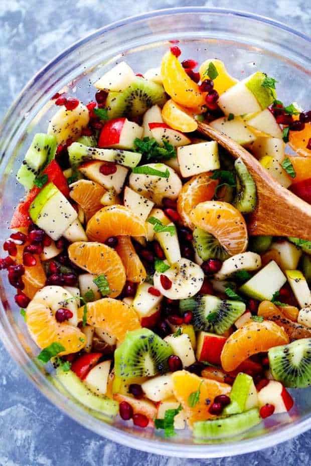 he Best Winter Fruit Salad is filled with clementines, kiwi, pears, apples, and pomegranate.  It gets tossed in a delicious honey lime poppy seed dressing and you won’t be able to get enough!