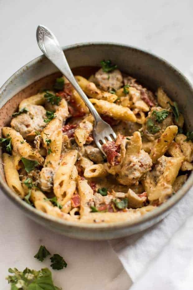 This easy one pot creamy Cajun sausage pasta recipe is flavorful comfort food at its best! Ready in just over half an hour. Perfect for a weeknight dinner.