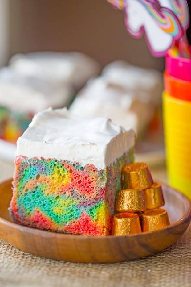 Rainbow Poke Cake With Whipped Cream made with no cake mix. Condensed milk makes this poke cake super moist and fluffy stabilized whipped cream won’t melt!