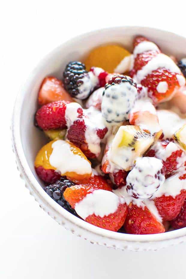 A colorful fruit salad of strawberry, kiwi, orange, raspberry, and blackberry that's drizzled with a sweet, creamy dressing infused with limoncello!