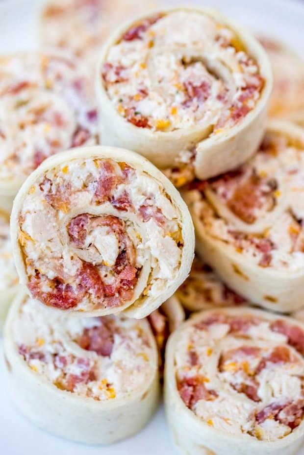 Chicken Bacon Ranch Pinwheels are and easy wrap your party guests will love with chicken, bacon, cheese and ranch seasoning. They're delicious hot and cold!
