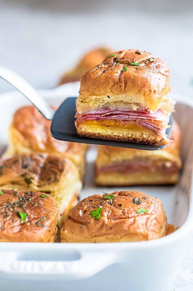 Ham and Cheese Sliders – perfect game day snacks and a great way for using up any leftover ham. Best of all, super easy to make with oven roasted ham, two cheeses and buttery garlic sauce over Hawaiian rolls.