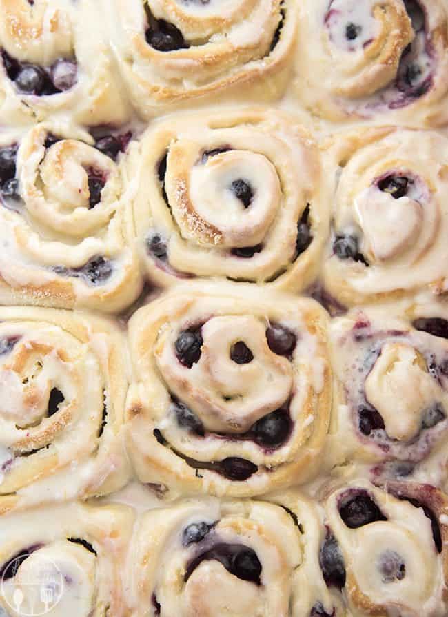 These tangy lemon blueberry sweet rolls have a perfectly soft and fluffy roll, bursting full of blueberries and topped with a lemon glaze. They have lemon throughout, with zest in the rolls, lemon sugar in the middle and a lemon glaze! These sweet rolls are irresistible