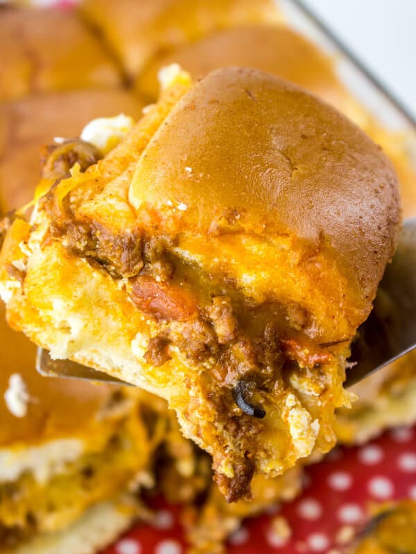 Gooey, melty with a little kick these Cheesy Taco Sliders are the PERFECT addition to your next fiesta!
