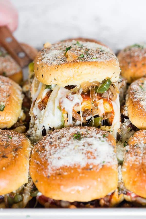 These baked supreme pizza sliders are the new baked sandwiches of your dreams. They taste just like loaded supreme pizza made with marinara sauce, spicy Italian sausage, pepperoni, mushrooms, green peppers, onions and lots of mozzarella cheese. You’ll love how easy these baked sliders are to make!