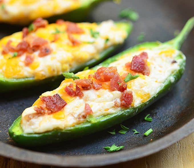 Jalapeno Poppers are stuffed with a mixture of cream cheese, shredded cheddar, and crumbled bacon and then baked until gooey and bubbly. Creamy and spicy, they’re like a party in your mouth!