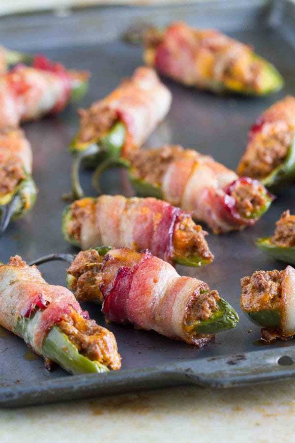 What is better than cheese stuffed jalapeños? Taco stuffed jalapeños, wrapped in bacon! These Taco Stuffed Bacon Wrapped Jalapeño Poppers take a normal jalapeño popper and give them a delicious Tex-Mex twist.