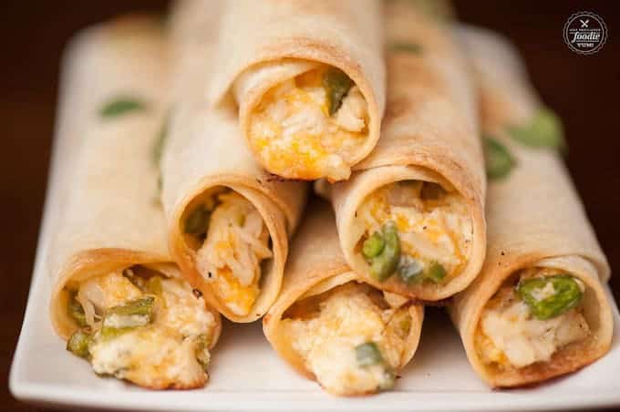 Feed a crowd at any game time party with these incredibly delicious and easy to make Jalapeno Popper Chicken Flautas finger foods.
