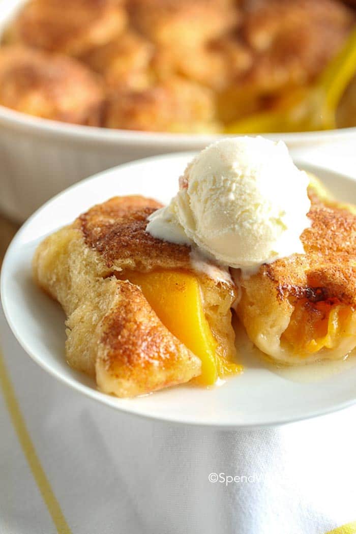 4 Ingredient Peach Dumplings may sound intimidating, with this recipe it is anything but! This yummy dessert comes together in a flash and requires only the simplest of ingredients, which you likely already have on hand in your pantry!  Sweet juicy peaches wrapped in a flaky dough and baked until browned.  Perfect served with a scoop of ice cream!