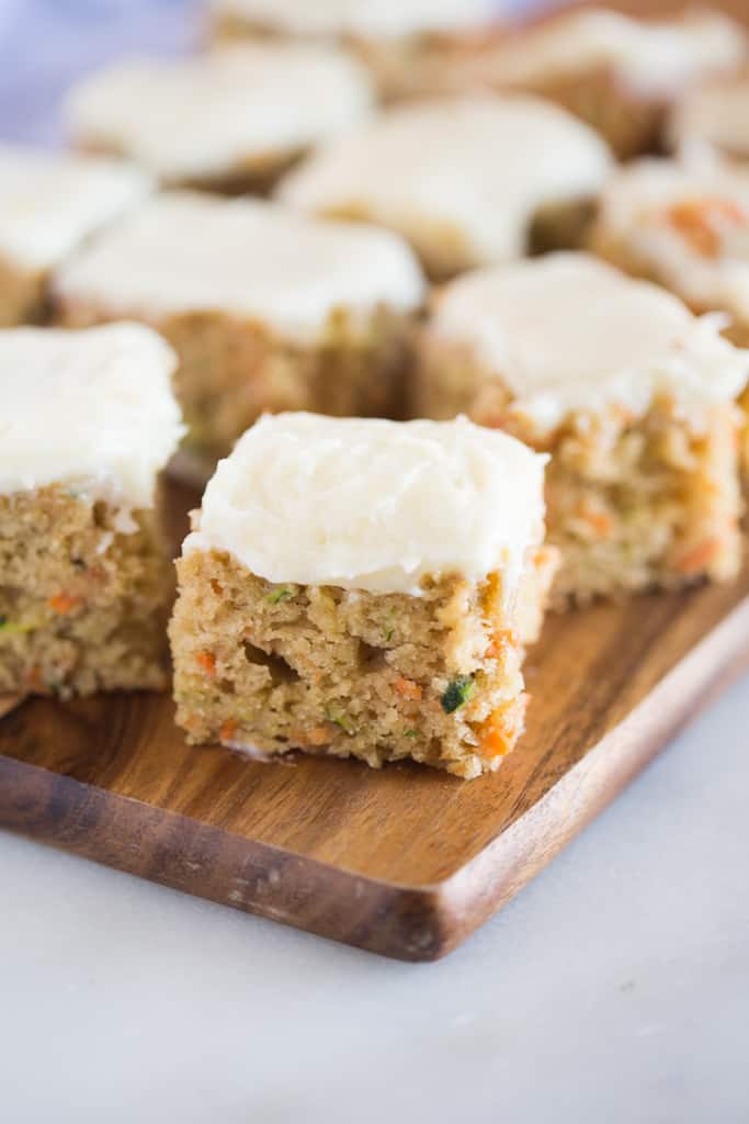 Carrot and Zucchini Bars with Lemon Cream Cheese Frosting are moist, perfectly sweet, and one of my favorite snack cakes. They taste amazing and are a great way to sneak vegetables into a yummy treat!