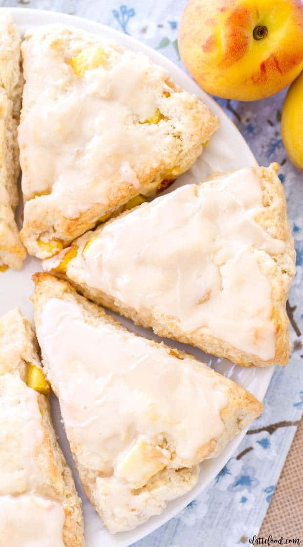 Peach Pie Scones taste just like peach pie! Peaches ’n Cream Scones are the perfect summer breakfast or summer brunch recipe! With their sweet vanilla glaze, these peach cream scones taste like they have a scoop of vanilla ice cream on top!