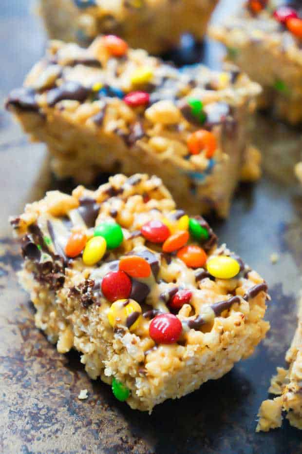 Peanut Butter Rice Krispie Treats are a fun dessert for the whole family. They are super easy to make and so delicious. These Rice Krispie squares are loaded with peanut butter and mini M&Ms.