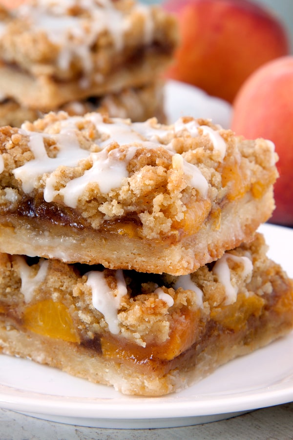 Peach Crumb Bars have a shortbread-like crust, cinnamon-spiced peach layer and a brown sugar crumb topping. So perfect for summer! Recipe contains a gluten-free option.