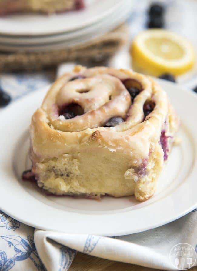Tangy Lemon Blueberry Sweet Rolls have a perfectly soft and fluffy roll, bursting full of blueberries and topped with a lemon glaze. They have lemon throughout, with zest in rolls, lemon sugar in the middle and a lemon glaze! These sweet rolls are irresistible!