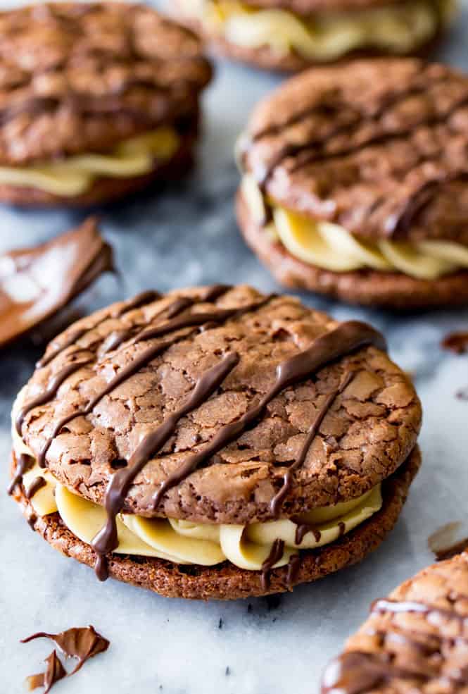 Chocolate Caramel Sandwich Cookies are rich chocolate cookies sandwiched around a salted caramel cream filling. They’re made entirely from scratch with a simple caramel frosting and dark chocolate drizzle, these are decadent, soul-soothing treats.