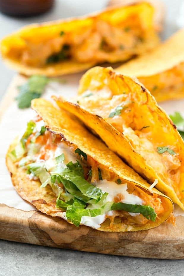 Oven Baked Buffalo Chicken Tacos – These super easy oven baked tacos are loaded with creamy buffalo chicken mixture and then topped with extra shredded cheese! Perfect recipe for taco Tuesday or any day of the week! So much flavor without all of the mess.