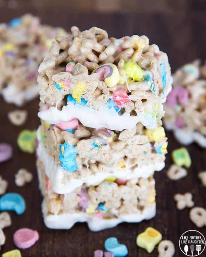 Lucky Charms Rice Krispie Treats are delicious gooey krispie treas made with lucky charm cereal instead! Dip Them in white chocolate for a super fun sweet treat!
