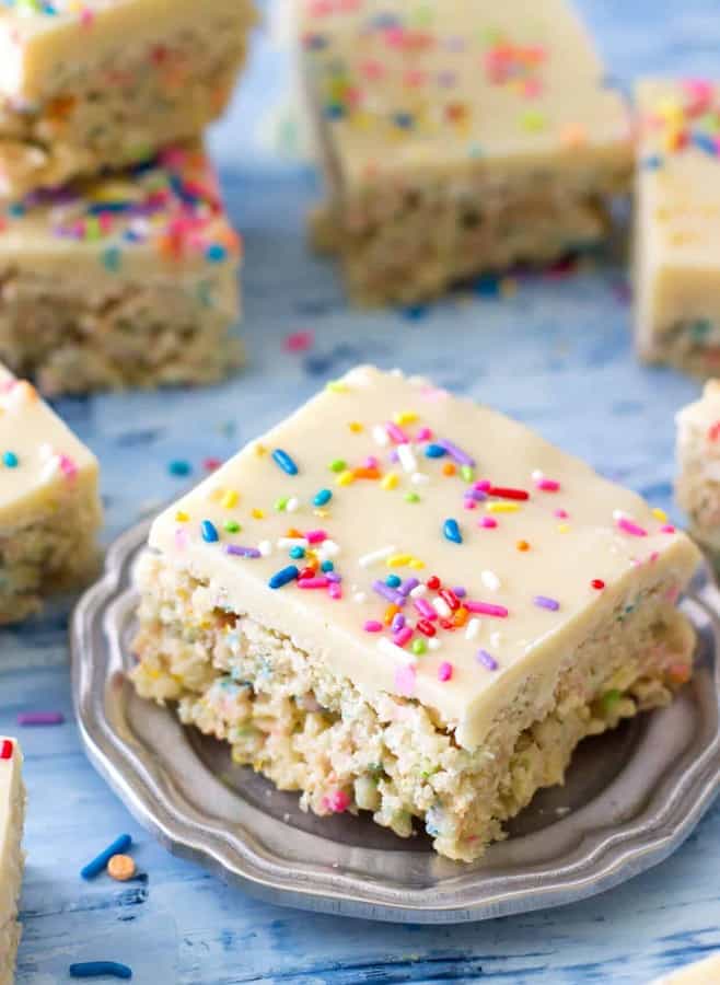 Sweet, generously-sprinkled funfetti cake batter rice krispie treats iced with a cake batter fudge frosting.