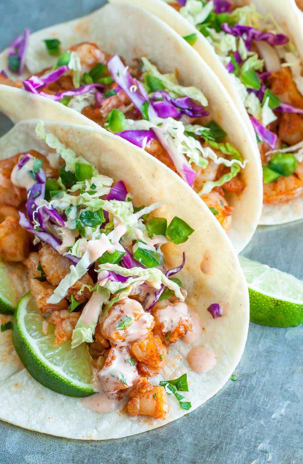 These Spicy Sriracha Shrimp Tacos are fast, flavorful, and topped with a zesty Cilantro Lime Slaw that will rock yours socks! Healthy, Dairy-Free, + Gluten-free.