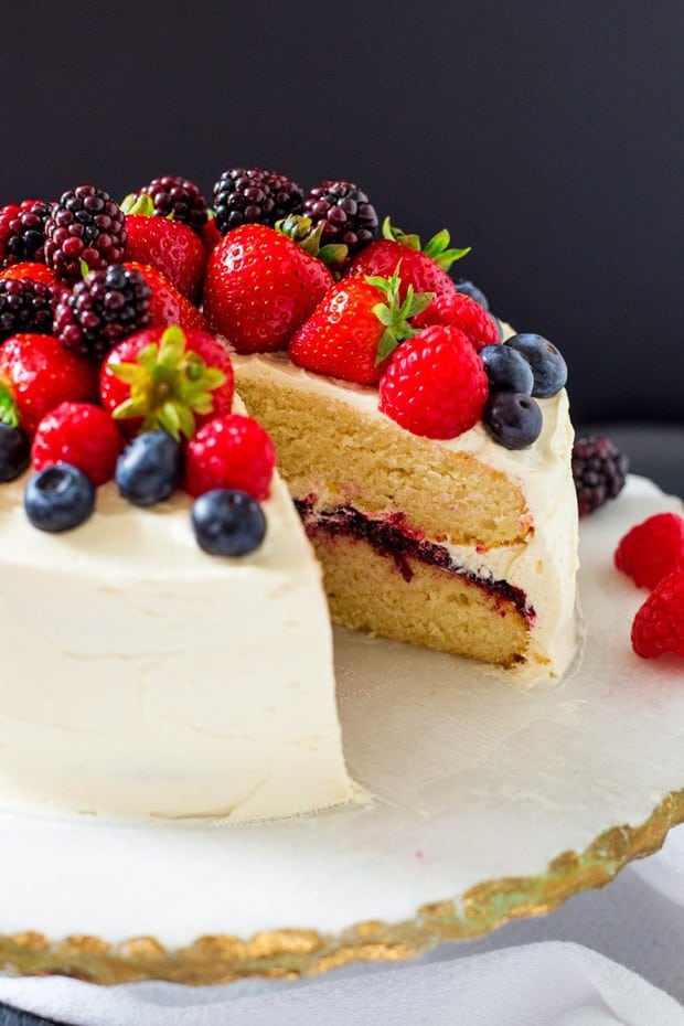 his Summer Berry Layer Cake is the ultimate cake for the berry lovers in your life with layers of vanilla cake, homemade berry jam and a myriad of fresh berries on top.