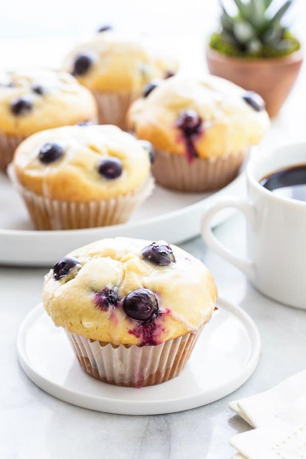 Blueberry Doughnut Muffins bake up high and mighty and are topped with a sweet and tangy lemon glaze. They’re perfect for breakfast or an afternoon snack.