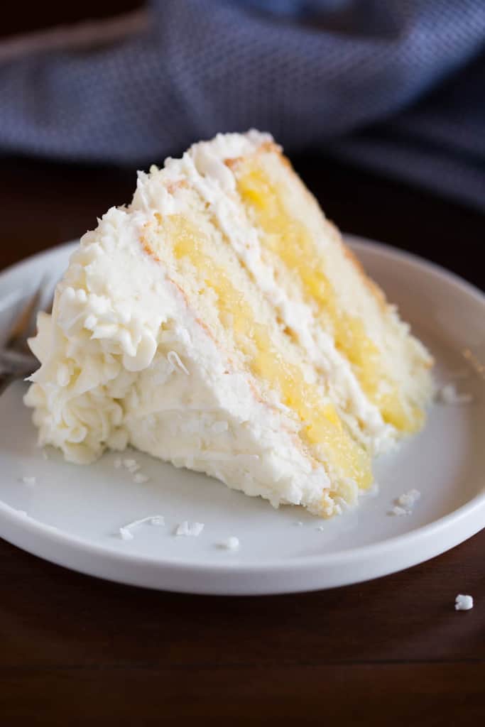 This is, dare I say it, the most AMAZING Coconut Cake to grace the earth. Layers of tender, moist coconut cake, fresh pineapple filling, and whipped coconut cream cheese frosting that all pair together perfectly. The final product is somewhat of a masterpiece, and could be one of my favorite cakes of all time!