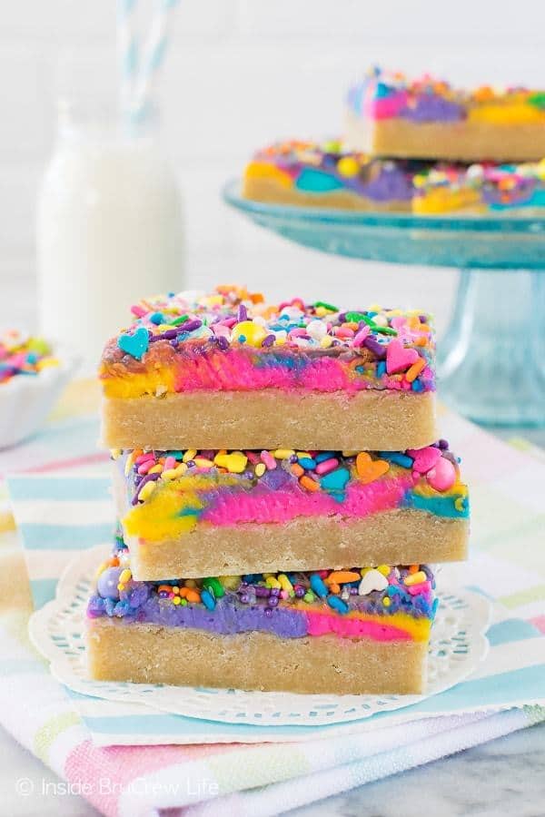 Colored frosting and lots of sprinkles add a fun flair to these easy Vanilla Unicorn Sugar Cookie Bars. Making and frosting the cookies in one pan makes them a very easy treat to make and share.