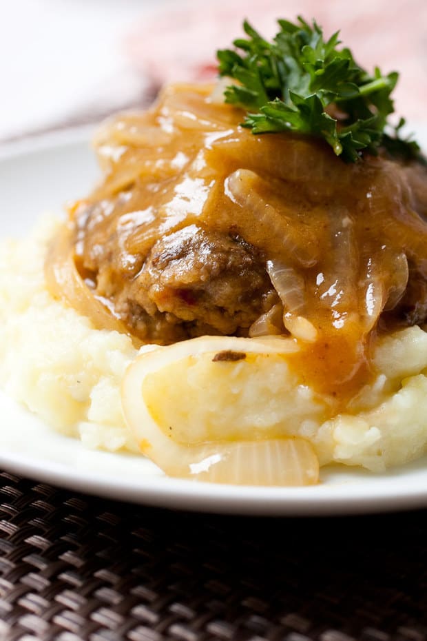 A real recipe for homemade Salisbury steak using no soup mixes. Seasoned beef patties seared and braised in a rich onion gravy. The best comfort food!