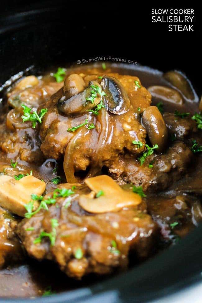 Slow Cooker Salisbury Steak is one of our favorite comfort foods.  Tender beef patties simmered in rich brown gravy with mushrooms and onions.  This is perfect served over mashed potatoes, rice or pasta!