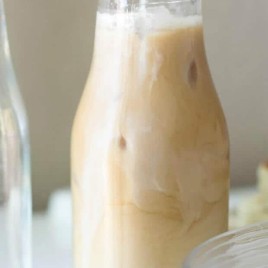 A close up of a glass of milk, with Coffee